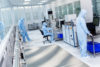 cleanroom with three people in bunny suits.